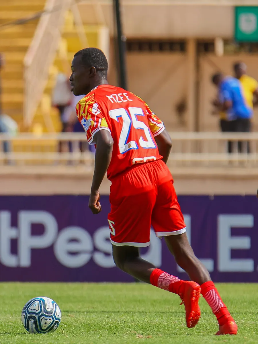 Brian Mzee, number 25, running with the ball