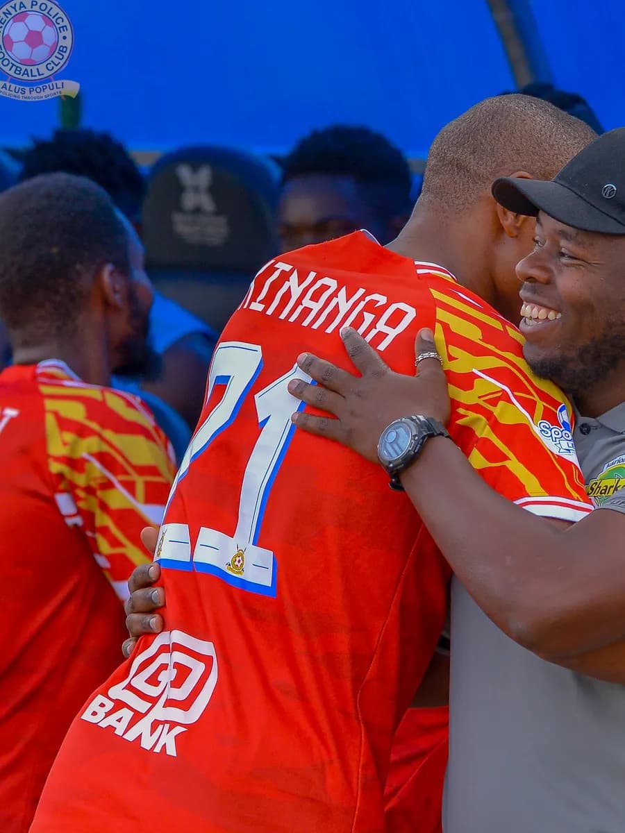 Clinton Kinanga embracing a member of staff on the touchline