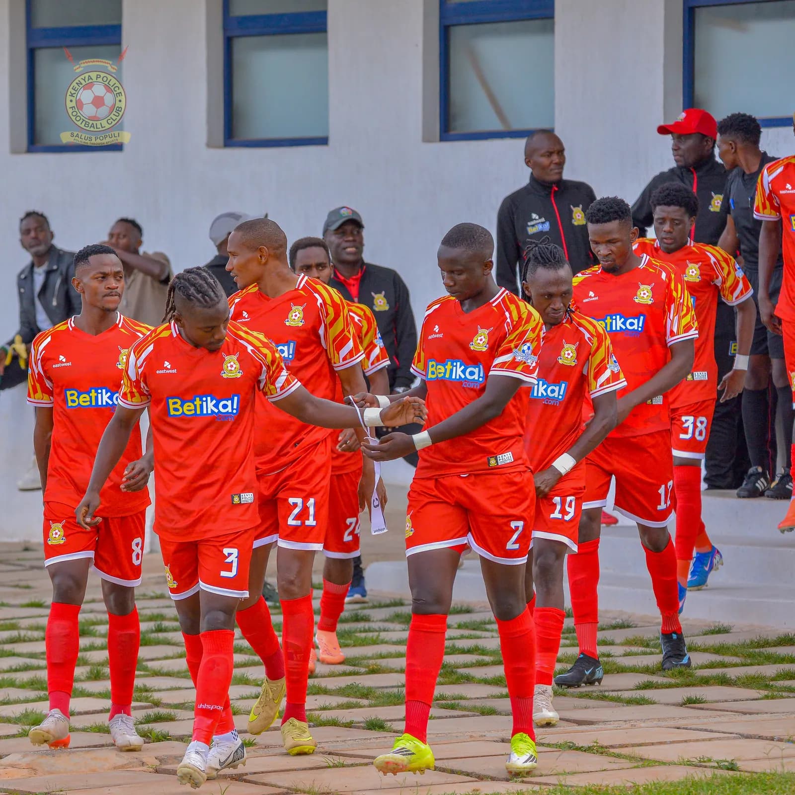 Kenya Police players walk out onto the pitch together